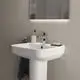 Weißer Waschplatz mit quadratischer Beckenform, ideal für Badezimmer. Ideal Standard Logo sichtbar. Zubehör wie Zahnbürste und Seife auf Ablage neben dem Waschbecken.